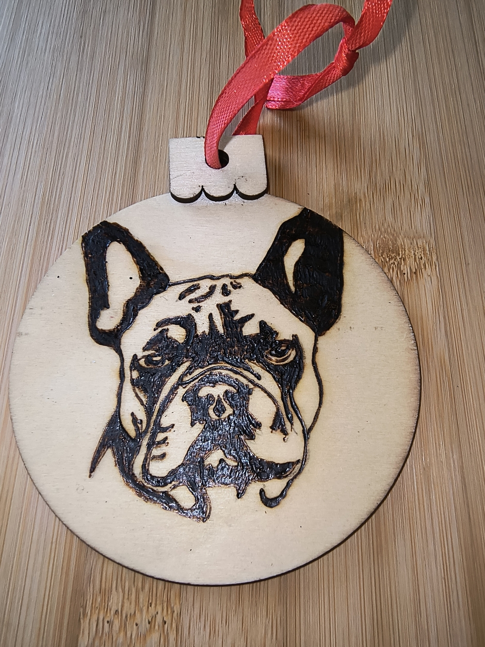 Hand Crafted Natural Wood Dog Ornament with Black Detailing and Red Ribbon